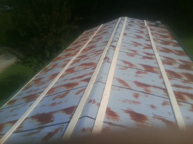 Rusted metal roof panels with new wood purlins before replacement — Storm Damage Roof Repair in Roselle by Roofing Brothers