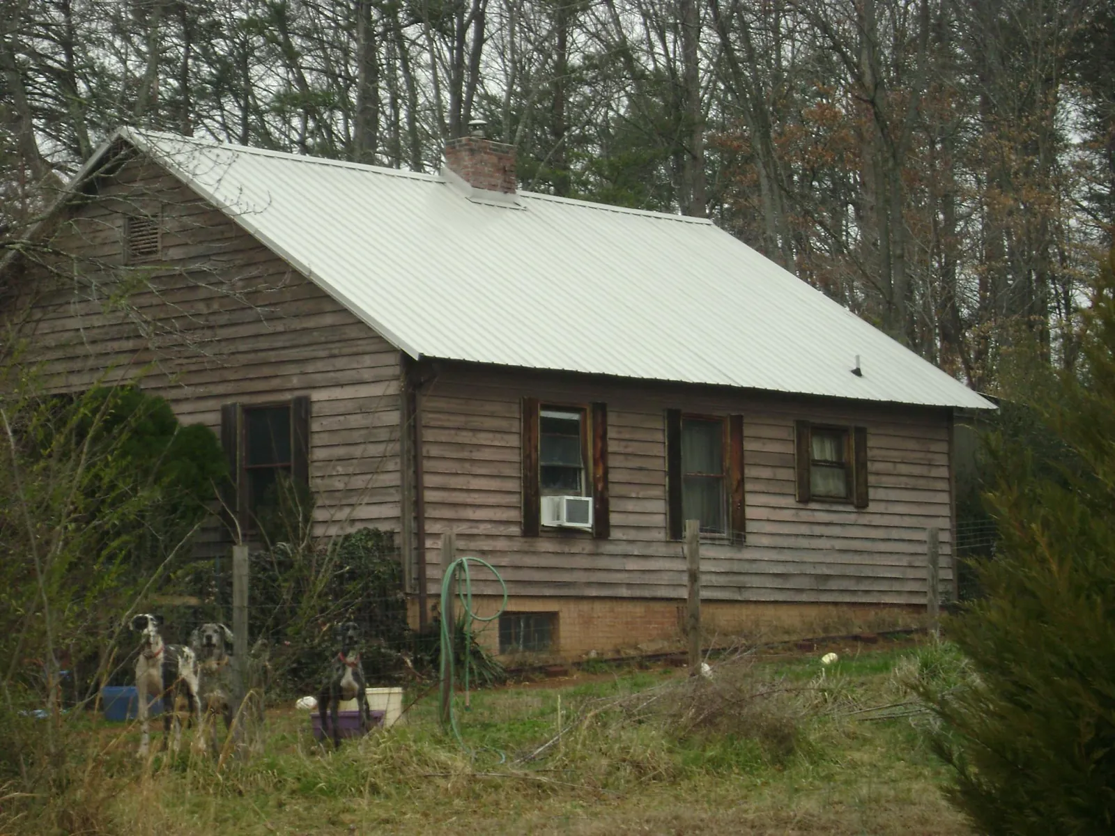 White metal roof on an old wood sided farmhouse, from a Metal Roof Installation job in Roselle